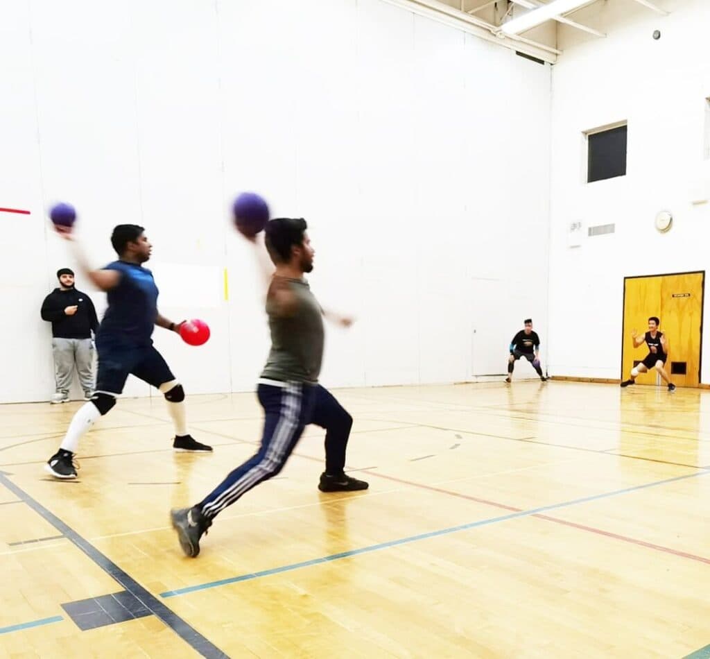 ATHL33T players diving for a dodgeball during a league night
